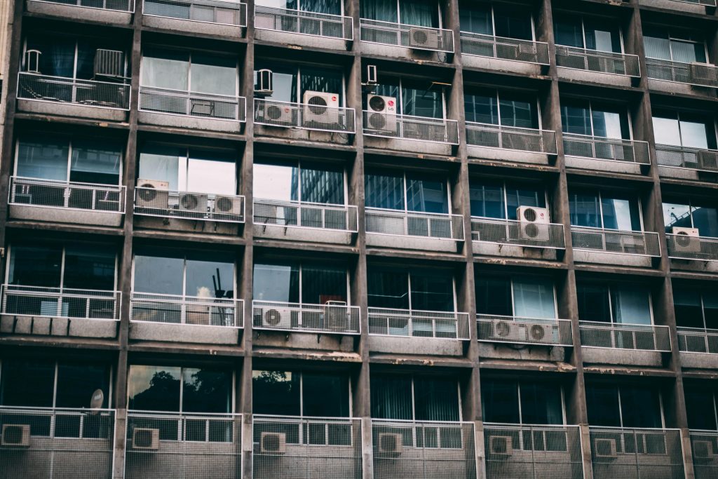 Exterior view of a residential building with multiple air conditioners, reflecting urban life in Sao Paulo.